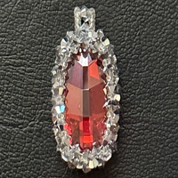 Orange oval-shaped crystal is approx. 25mm x 16mm surrounded by Swarovski Elements Crystals and seed beads. 